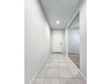 Hallway with tile flooring leading to the front door at 19954 W Moonlight Path, Buckeye, AZ 85326