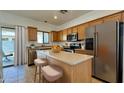 Modern kitchen with stainless steel appliances and a breakfast bar with seating at 22507 N 31St Ave # 11, Phoenix, AZ 85027