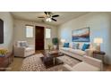 Bright living room featuring a ceiling fan, comfortable seating, and a decorative rug at 22507 N 31St Ave # 11, Phoenix, AZ 85027