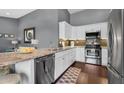Bright kitchen featuring stainless steel appliances, granite countertops, and white cabinetry at 2551 W Sawtooth Way, San Tan Valley, AZ 85144