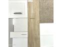 Interior design sample board with white cabinets, quartz countertop, wood flooring, and carpet swatch at 25817 N 147Th Dr, Surprise, AZ 85387