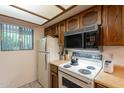 Efficient kitchen featuring vintage appliances, wood cabinets, and great natural light at 3131 W Cochise Dr # 144, Phoenix, AZ 85051