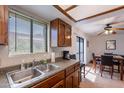 Open kitchen flows into the dining area, featuring updated countertops and wood cabinets at 3131 W Cochise Dr # 269, Phoenix, AZ 85051