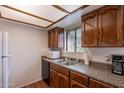 View of the traditional kitchen featuring wood cabinets, updated countertops, and stainless steel sink at 3131 W Cochise Dr # 269, Phoenix, AZ 85051
