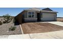 Charming single-story home with a two-car garage, and drought-tolerant landscaping with an attractive border at 38065 W Frascati Ave, Maricopa, AZ 85138