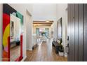 Bright foyer featuring wood-look tile floors, white walls, and artistic decor leading to the living spaces at 4050 S Thistle S Dr, Chandler, AZ 85248