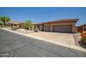 Well maintained home with three-car garage and low maintenance desert landscaping, situated on a quiet street at 41731 N Rolling Green Way, Anthem, AZ 85086