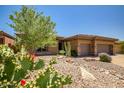 Charming single-story home with desert landscaping, a three-car garage and inviting curb appeal at 41731 N Rolling Green Way, Anthem, AZ 85086