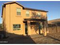 The back exterior of the house features a covered patio and a large yard perfect for outdoor activities at 4722 S 238Th Ln, Buckeye, AZ 85326