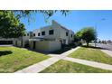 Exterior view of a two story townhouse with low maintenance yard and covered entryways along a sidewalk at 4752 W Palo Verde Dr, Glendale, AZ 85301