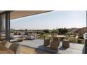 Expansive outdoor patio with comfortable seating, dining, and scenic mountain views at 4849 N Camelback Ridge Rd # B403, Scottsdale, AZ 85251