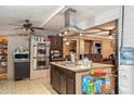 Kitchen showcasing a functional island with a cooktop and modern stainless steel oven, perfect for cooking at 5615 W Camelback Rd, Phoenix, AZ 85031