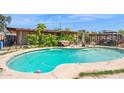 Inviting backyard pool surrounded by lush greenery and a shaded pergola, perfect for relaxation at 5615 W Camelback Rd, Phoenix, AZ 85031
