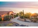 Charming home with a desert landscape, tiled roof, and sunlit driveway, perfect for tranquil living at 5921 E Leisure Ln, Carefree, AZ 85377