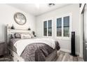 Cozy bedroom features modern gray color scheme, stylish decor, and natural light at 597 S 221St Dr, Buckeye, AZ 85326