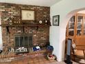 Charming brick fireplace with mantle and brick hearth, perfect for cozy evenings at home at 6637 E Culver St, Scottsdale, AZ 85257