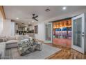 Living room with a view of a pool, hardwood floors, an open layout, and a modern fan at 6901 E Oak St, Scottsdale, AZ 85257
