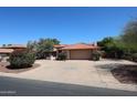Charming single-story home with a tile roof, desert landscaping, and a spacious driveway and front yard at 6940 W Willow Ave, Peoria, AZ 85381