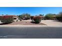 Attractive one-story home with mature desert landscaping, spacious driveway, and red tile roof under clear blue skies at 6940 W Willow Ave, Peoria, AZ 85381
