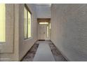 Welcoming front entrance with a secure door, sidelight, and attractive landscaping elements at 7006 E Jensen St # 48, Mesa, AZ 85207