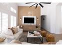 Elegant living room with paneled accent wall, sleek TV console, and bright natural light at 802 N Lisbon Dr, Chandler, AZ 85226