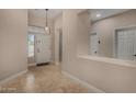 Bright and airy entryway with neutral walls, tiled flooring, and a front door window at 927 S Ash St, Gilbert, AZ 85233