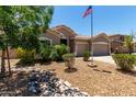 Inviting home exterior with desert landscaping, stone accents, and a well-maintained lawn at 927 S Ash St, Gilbert, AZ 85233