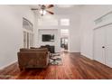 Open-concept living room with hardwood floors, tall ceilings, a media niche, and ample natural light at 1022 S Butte Ln, Gilbert, AZ 85296