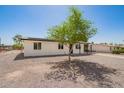 Single-story home showcasing a gravel yard, simple covered entry, and convenient covered parking at 10693 N Arapaho Dr, Casa Grande, AZ 85122
