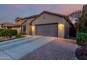 Beautiful single-story home with synthetic front lawn and concrete driveway at 11829 W Patrick Ln, Sun City, AZ 85373