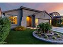 Attractive single-story home with landscaped front yard, synthetic lawn and desert landscaping at 11829 W Patrick Ln, Sun City, AZ 85373