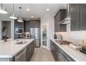 Modern kitchen featuring stainless steel appliances, a kitchen island and lots of storage at 12233 W Caraveo Pl, Peoria, AZ 85383