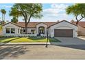 Charming single-story home showcasing a lush front yard and inviting curb appeal at 16428 N 59Th St, Scottsdale, AZ 85254