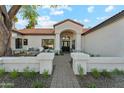 Charming front entrance featuring a paved walkway and comfortable outdoor seating at 16428 N 59Th St, Scottsdale, AZ 85254