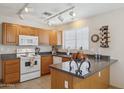 Well-lit kitchen featuring track lighting and a window over the sink at 17229 N 51St Dr, Glendale, AZ 85308