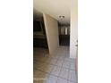 View of tiled entry and living room with bright natural light and sliding doors at 189 Laguna E Dr, Litchfield Park, AZ 85340