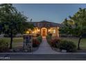 Charming home with stone accents, a tile roof, and a well-manicured front yard at 21228 E Excelsior Ave, Queen Creek, AZ 85142