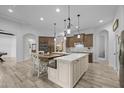 Bright and airy kitchen with an oversized island, wooden cabinetry, and plenty of workspace at 21228 E Excelsior Ave, Queen Creek, AZ 85142