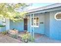 Inviting front porch showcasing decorative ironwork, a flowerbed, and the home's entrance at 2335 W Campus Dr, Phoenix, AZ 85015