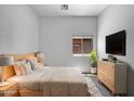 Modern bedroom featuring a platform bed, nightstands, a TV and desert views at 2971 N Rosewood Ave, Casa Grande, AZ 85122