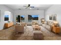 Bright living room with tan furniture, area rug, neutral walls, and backyard views at 2971 N Rosewood Ave, Casa Grande, AZ 85122
