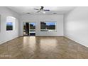 Bright, empty living room with tile floors and a large window looking out to the backyard pool at 2971 N Rosewood Ave, Casa Grande, AZ 85122