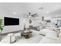 Bright living room featuring sleek floors, modern furnishings and an adjacent open kitchen at 3002 W Mandalay Ln, Phoenix, AZ 85053