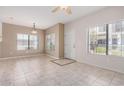 Bright living room boasts tile flooring, neutral paint, and plenty of natural light from large windows at 3150 E Beardsley Rd # 1091, Phoenix, AZ 85050