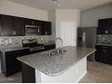 Modern kitchen with granite counters, stainless steel appliances and ample cabinet space at 4032 N 308Th Dr, Buckeye, AZ 85396