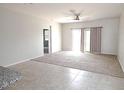 Spacious living room featuring tile and carpet floors and patio access at 4032 N 308Th Dr, Buckeye, AZ 85396