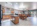 Bright kitchen with island, stainless steel appliances, and an open floor plan at 42406 W Posada Dr, Maricopa, AZ 85138