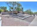 Charming single-story home featuring a large driveway, desert landscaping, and an American flag proudly displayed at 511 E Port Au Prince Ln, Phoenix, AZ 85022