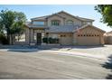 Attractive two-story home featuring a well-manicured lawn and a three car garage at 5281 W Quail Ave, Glendale, AZ 85308