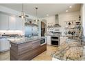 Modern kitchen featuring custom cabinetry, granite countertops, and a chef-grade stainless steel appliances at 5281 W Quail Ave, Glendale, AZ 85308